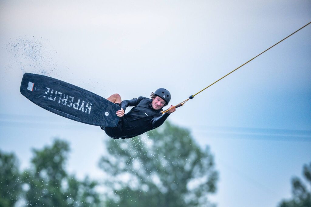 Rider executando manobra de wakeboard no cable park